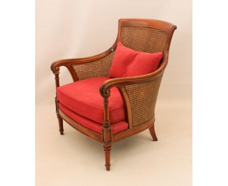 A berg&egrave;re armchair in the 19th century French taste - late 20th century, the caned scroll back and swept scrolled arms