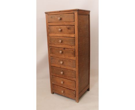 An eight-drawer waxed pine semainier or tall chest of drawers - first quarter 20th century, later turned oak handles, raised 