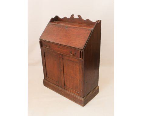 A 19th century mahogany bureau for restoration - the shaped three-quarter gallery above a fall opening to reveal a central cu