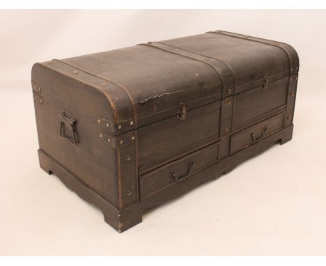 A dome-top trunk or chest in 19th century style - modern, the dark-grey stained wood with antiqued brass hardware, the hinged