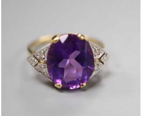 An Art Deco style yellow metal, amethyst and diamond seven-stone ring, the oval amethyst claw-set, size N, gross 3.7 grams.