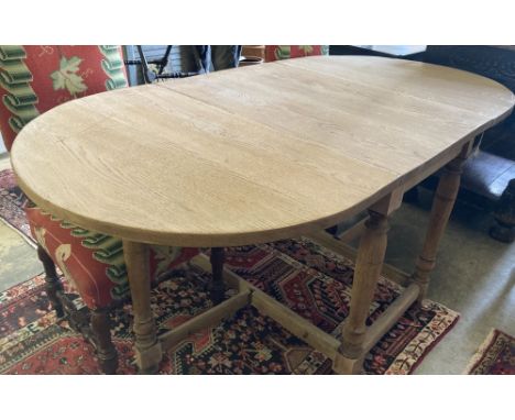 An 18th century style oak gateleg dining table, 175cm extended