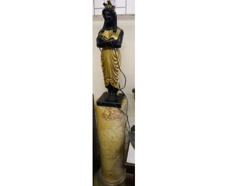 A pair of carved and giltwood 'Egyptian' figure table lamps, on reconstituted marble columns, total height 204cm (with shades