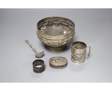 An Edwardian silver christening mug, a Victorian silver foliate sifter spoon, an Indian? bowl, Chinese napkin ring &amp; a sn