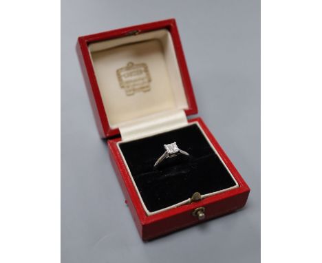 A modern Cartier platinum and Princess cut solitaire diamond ring, size M, gross 4.8 grams, the stone weighing approximately 