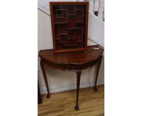 A Chinese hardwood demi-lune table together with a hanging cabinet, width 42cm, depth 9cm, height 56cm