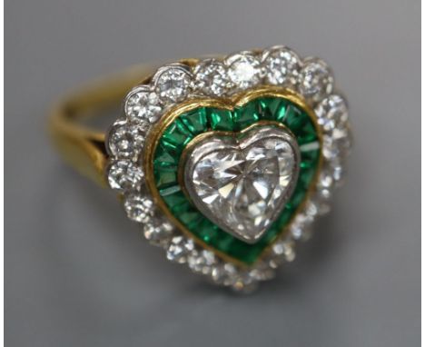 A modern 18ct gold, heart shaped diamond and emerald cluster set heart shaped dress ring, size N, gross 4.7 grams.CONDITION: 