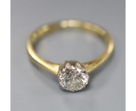 A modern 18ct gold and solitaire diamond ring, size M, gross 2.9 grams, the stone weighing approximately 0.70ct, with an esti