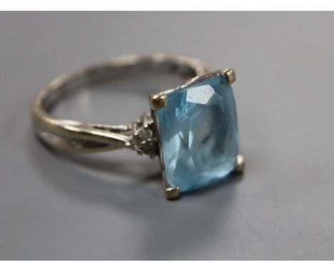 A modern 18ct white gold, blue topaz and diamond set dress ring, size S, gross 6.2 grams.