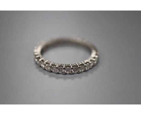 A platinum and diamond full eternity ring, claw-set with small round diamonds, size N, gross 2.8 grams.
