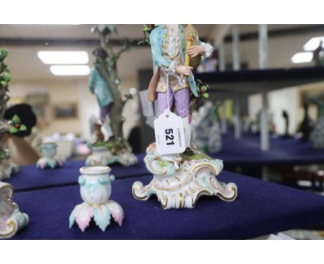A pair of Meissen bucolic figural candelabra, 19th century, the gentleman figure playing bagpipes and the lady a pipe, standi