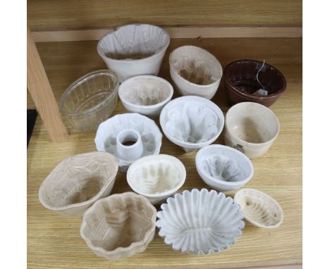 A collection of ceramic and toleware jelly moulds