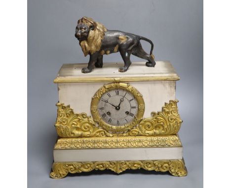 A French gilt and silvered mantel clock, with associated lion surmount, height 40cm