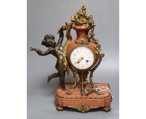 A 19th century French ormolu mounted rouge marble mantel clock, cast with putti, height 36cm