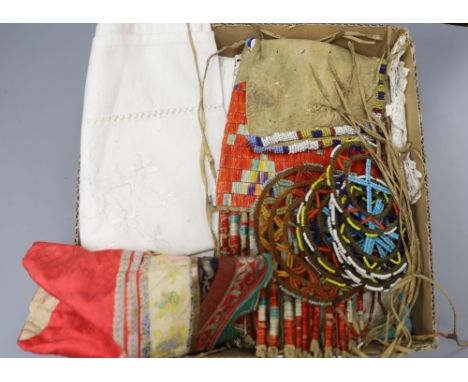 A native North American North Plains beaded leather pouch, a pair of Chinese embroidered shoes, further beadwork roundels and