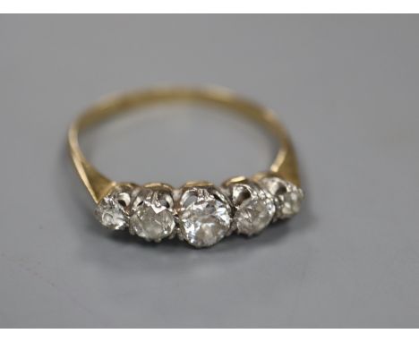 A yellow metal and graduated five stone diamond set half hoop ring, size O, gross 2.1 grams.CONDITION: No visible damage to a