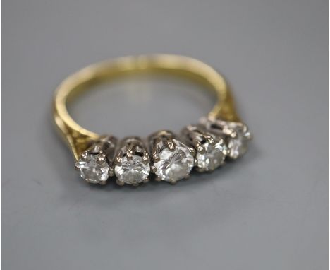 An 18ct and graduated five stone diamond set half hoop ring, size O, gross 3.6 grams.CONDITION: No visible damage to any of t