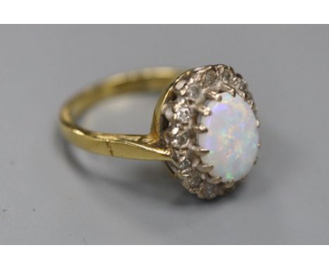 A modern 18ct gold, white opal and diamond set oval cluster ring, size J, gross 4.4 grams.CONDITION: Numerous surface abrasio