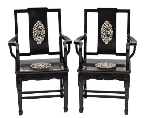 A pair of Chinese black lacquer and mother of pearl inlaid open armchairs:, decorated with oval and circular foliate scroll p