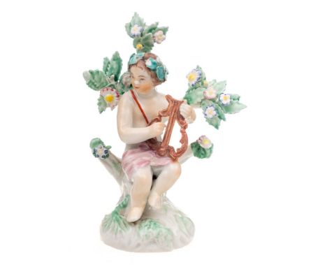 A Plymouth figure of a putto: playing a lyre and seated on a tree stump mound base with flowering bocage, circa 1768-70, 11cm