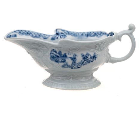 A rare First Period Worcester high-footed sauceboat: of rococo silver shape moulded with floral sprays, scrollwork panels and