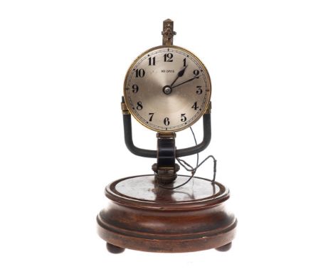 An early Bulle electric clock: the movement connected to a battery set within the base, the round silvered dial having black 
