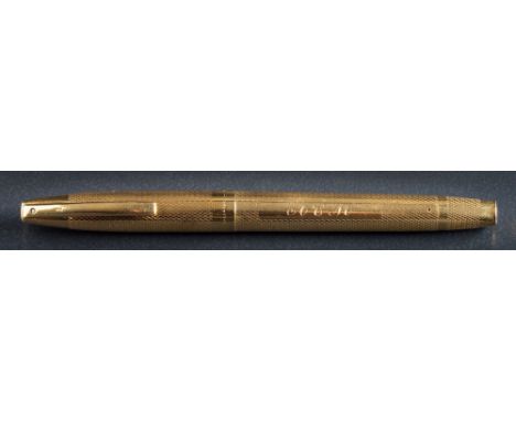 An 18ct gold engine turned 'Sheaffer' fountain pen: initialled 'A.C.M'  the nib stamped 'SHEAFFER 14K', together with case. 