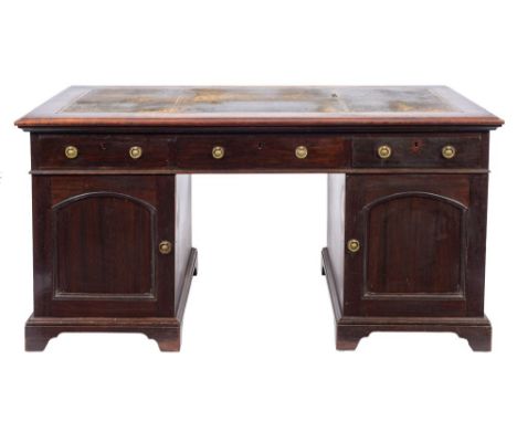 An Edwardian mahogany pedestal desk:, the rectangular top with a moulded edge, inset with a divided panel of tooled leather, 