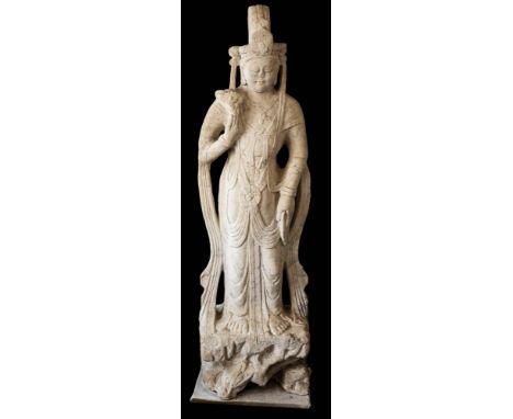 A large Chinese micaceous marble statue of Guanyin: in the Tang style, wearing traditional robes and headdress, holding a flo