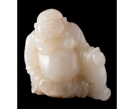 A Chinese jade carving of Budai: the stone of pale celadon colour with white and russet inclusions to the base, 5.5cm high.