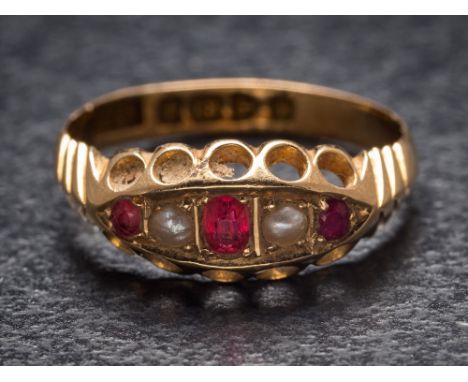 An 18ct gold, ruby doublet and seed pearl five-stone ring: Chester assay marks to shank, ring size M. 