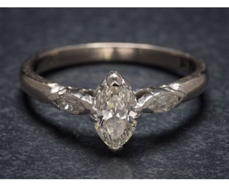 A marquise-cut diamond single-stone ring: the marquise-cut diamond approximately 7mm x 3.8mm in claw setting between marquise