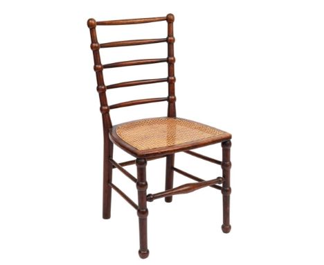 An Arts &amp; Crafts mahogany side chair: with bobbin-turned five-bar back and cane seat, 84cm (3ft 1in) high.