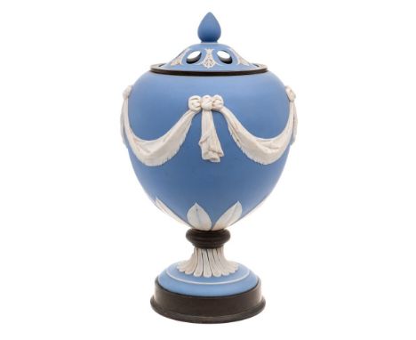 A 'Wedgwood' blue and white jasperware urn and pierced cover: with relief ribbon-tied drapery swag, anthemion and lappet deco