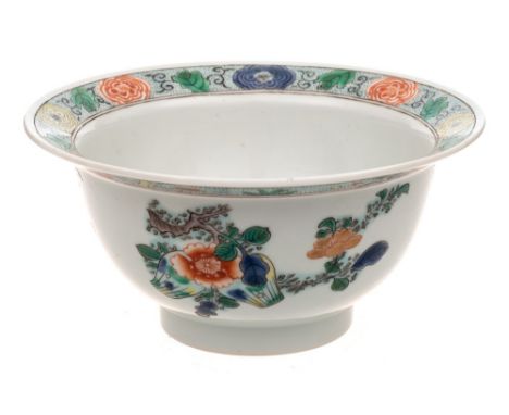 A Chinese porcelain bowl: of circular form with everted rim painted in the famille verte palette with prunus, pine, peony, fi