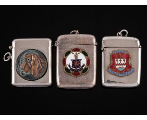 Two silver plated vesta cases: of rectangular outline bearing enamel coats-of-arms and another vesta case decorated with the 