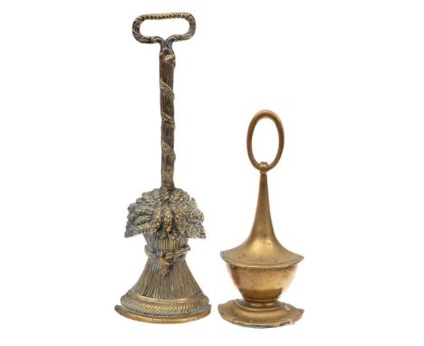 An early 19th Century brass door stop: in the form of a wheat-sheaf, 41cm high,  an urn-shaped door stop, 29cm high,  a pair 