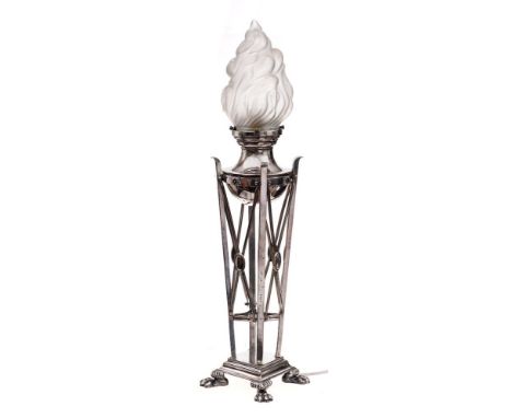 An early 20th Century plated table lamp: the circular reservoir with opaque glass flame shade, supported on four square colum