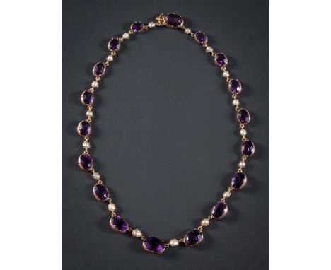 An early 20th Century gold, amethyst and seed-pearl necklace: with graduated, oval amethysts separated by single seed-pearls 