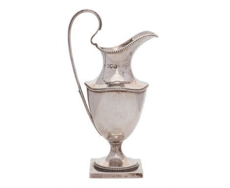 A late Victorian silver pedestal cream jug, maker Haseler Brothers, London, 1899: of baluster form with beaded borders, raise
