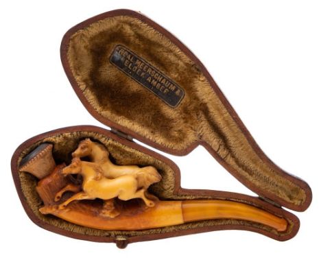 A late 19th century carved Meerschaum pipe: decorated with two prancing horses, with amber mouthpiece, 13cm. long cased.