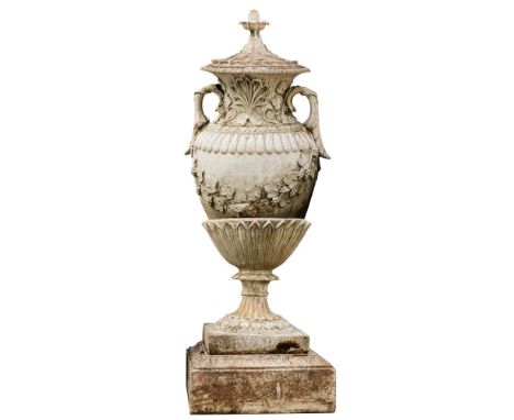 A large reconstituted stone garden urn: of neoclassical outline, the foliate decorated cover with pineapple finial, the body 