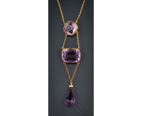 An amethyst mounted three-stone lavalier: suspending a pear-shaped amethyst drop, the bolt ring clasp possibly stamped '9ct',
