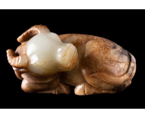A Chinese jade carving of a water buffalo: the stone of mottled celadon, russet and grey colour, 7cm.