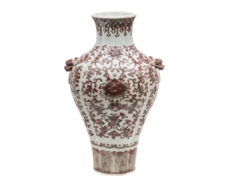 A Chinese underglaze copper-red decorated quadrilobed vase: with grotesque mask ring handles, painted with peonies and scroll