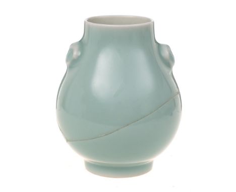 A small Chinese celadon vase: of pear shape with mask head handles and on cylindrical foot, underglaze blue six-character Qia