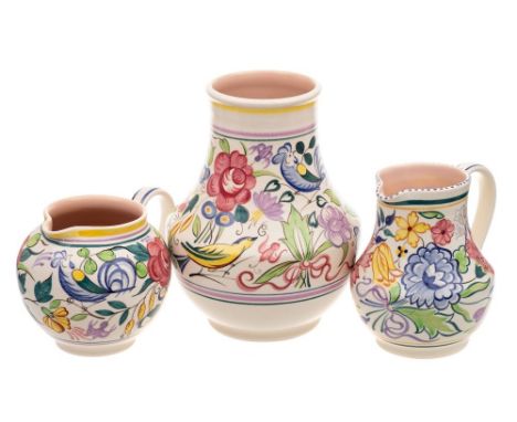 A Poole Pottery vase and jug and a further jug: decorated after a design by Truda Carter, the former painted in the LE patter