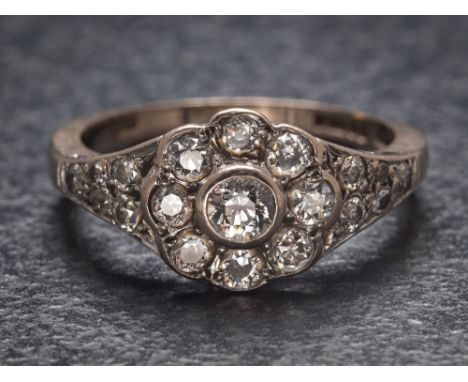 An 18ct white gold and diamond antique-style, floral cluster ring: set with round old brilliant-cut diamonds estimated to wei