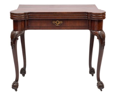 A George II carved mahogany triple top games table: with projecting rounded corners, the baize lined hinged top with counter 