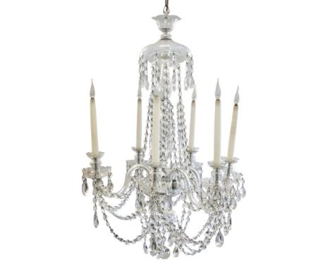 A cut glass six branch chandelier:, with a central urn and baluster canopied stem and scrolling branches hung with festoons o